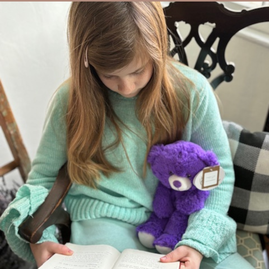 Child snuggling a lavender bear, easing winter restlessness and promoting relaxation